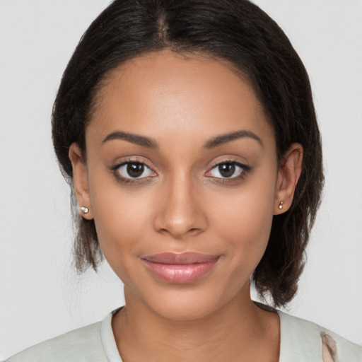 Joyful latino young-adult female with medium  brown hair and brown eyes