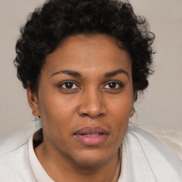 Joyful black adult female with short  brown hair and brown eyes