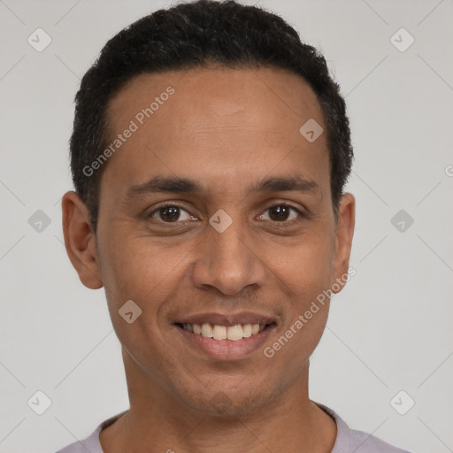 Joyful latino young-adult male with short  black hair and brown eyes