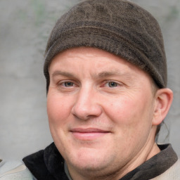 Joyful white adult male with short  brown hair and grey eyes