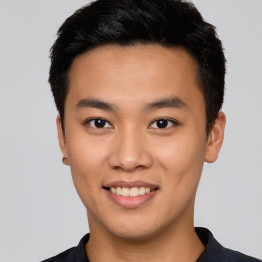 Joyful asian young-adult male with short  black hair and brown eyes