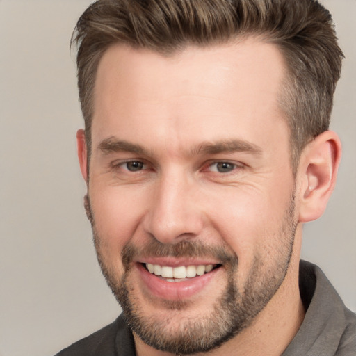 Joyful white adult male with short  brown hair and brown eyes