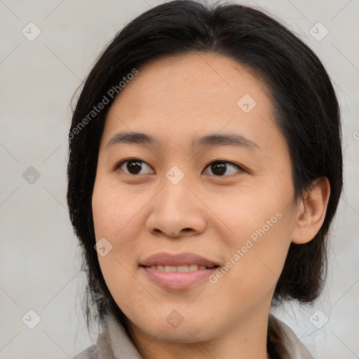 Joyful asian young-adult female with medium  brown hair and brown eyes