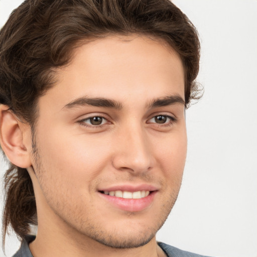 Joyful white young-adult male with medium  brown hair and brown eyes