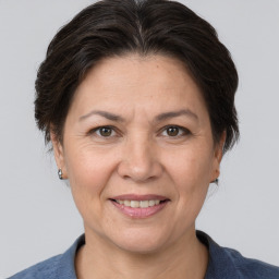 Joyful white adult female with medium  brown hair and brown eyes