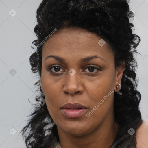 Joyful black young-adult female with long  brown hair and brown eyes