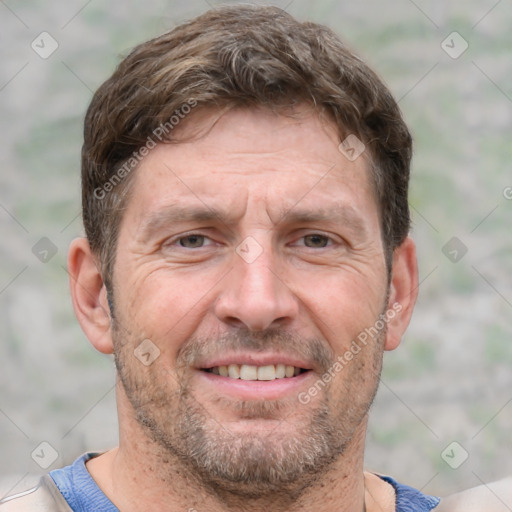 Joyful white adult male with short  brown hair and grey eyes