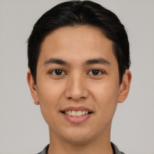 Joyful asian young-adult male with short  black hair and brown eyes