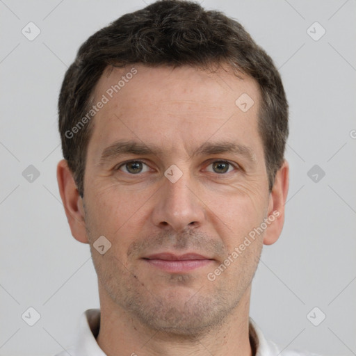 Joyful white adult male with short  brown hair and brown eyes