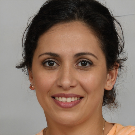 Joyful white young-adult female with medium  brown hair and brown eyes