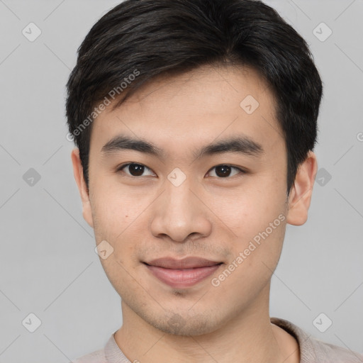 Joyful asian young-adult male with short  brown hair and brown eyes