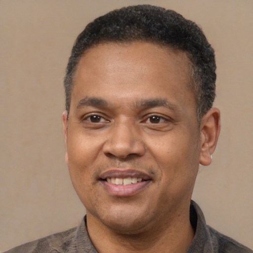 Joyful latino adult male with short  black hair and brown eyes