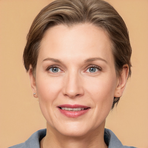 Joyful white adult female with medium  brown hair and grey eyes