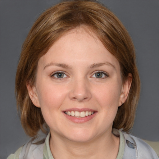 Joyful white young-adult female with medium  brown hair and blue eyes