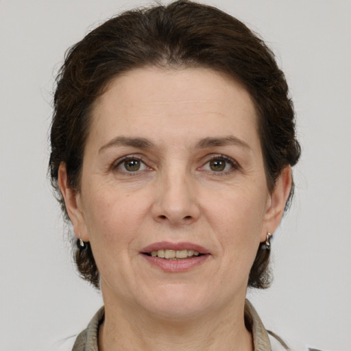 Joyful white adult female with short  brown hair and brown eyes