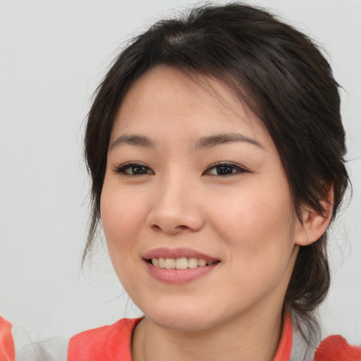 Joyful asian young-adult female with medium  brown hair and brown eyes