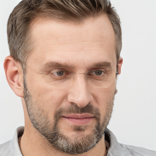 Joyful white adult male with short  brown hair and grey eyes