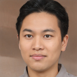 Joyful asian young-adult male with short  brown hair and brown eyes