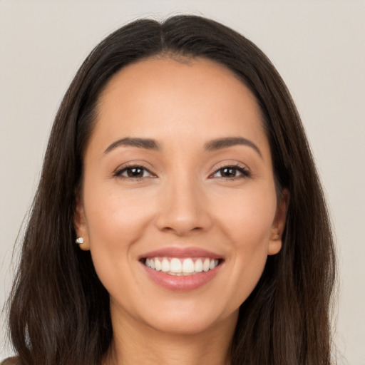 Joyful white young-adult female with long  brown hair and brown eyes