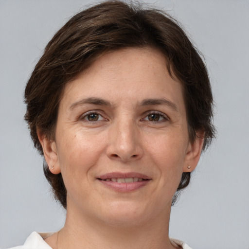 Joyful white adult female with short  brown hair and brown eyes