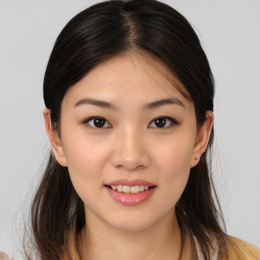 Joyful asian young-adult female with long  brown hair and brown eyes