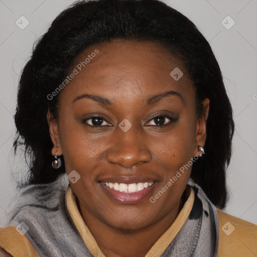 Joyful black adult female with medium  brown hair and brown eyes