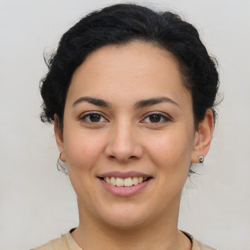 Joyful latino young-adult female with medium  brown hair and brown eyes