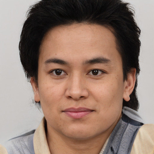 Joyful latino young-adult male with medium  brown hair and brown eyes