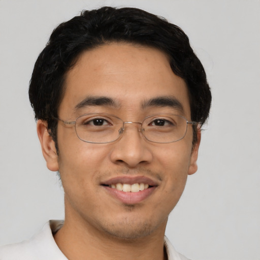 Joyful asian young-adult male with short  brown hair and brown eyes