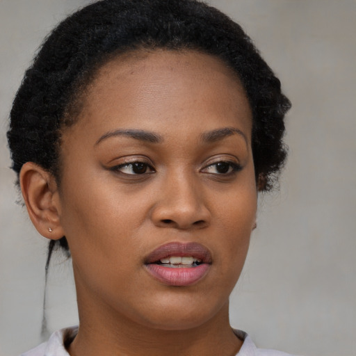 Joyful black young-adult female with short  brown hair and brown eyes
