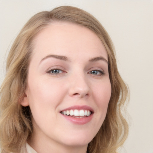 Joyful white young-adult female with medium  brown hair and blue eyes