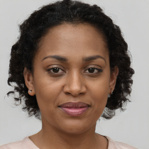 Joyful black young-adult female with short  brown hair and brown eyes