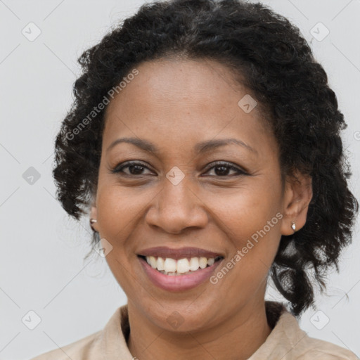 Joyful black adult female with medium  brown hair and brown eyes