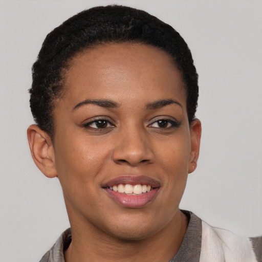Joyful black young-adult female with short  brown hair and brown eyes