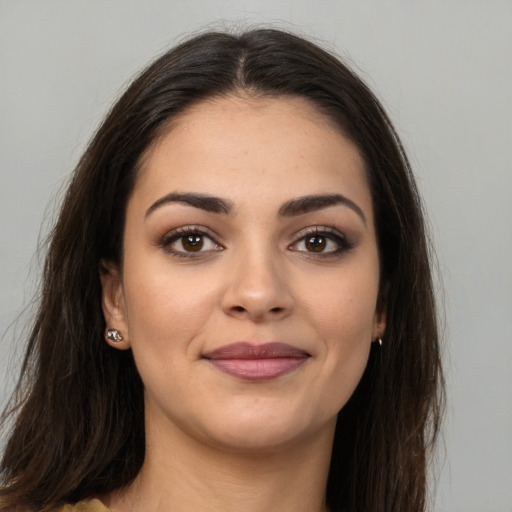 Joyful white young-adult female with long  brown hair and brown eyes