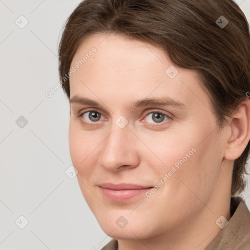 Joyful white young-adult female with short  brown hair and grey eyes