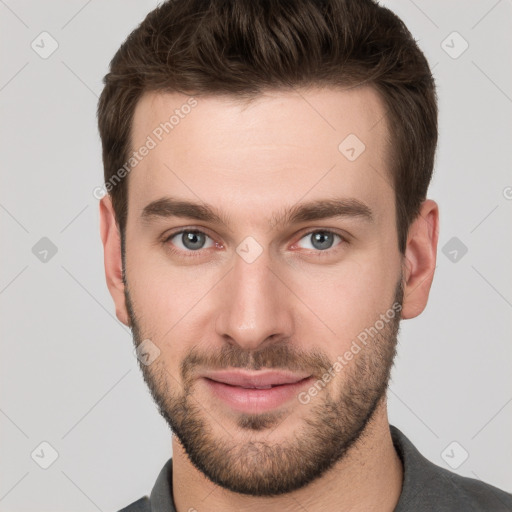 Joyful white young-adult male with short  brown hair and grey eyes