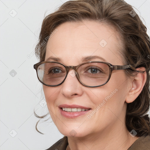 Joyful white adult female with medium  brown hair and blue eyes