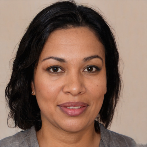 Joyful white adult female with medium  brown hair and brown eyes