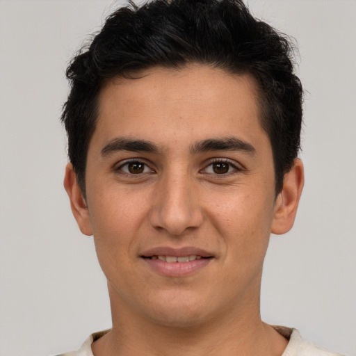 Joyful latino young-adult male with short  brown hair and brown eyes