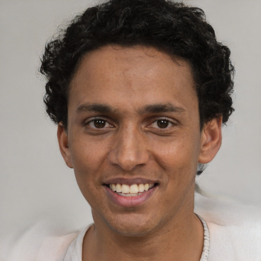 Joyful black young-adult male with short  black hair and brown eyes