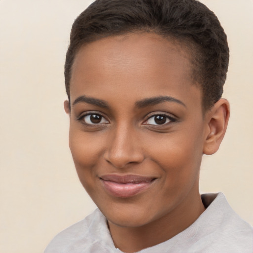 Joyful black young-adult female with short  brown hair and brown eyes