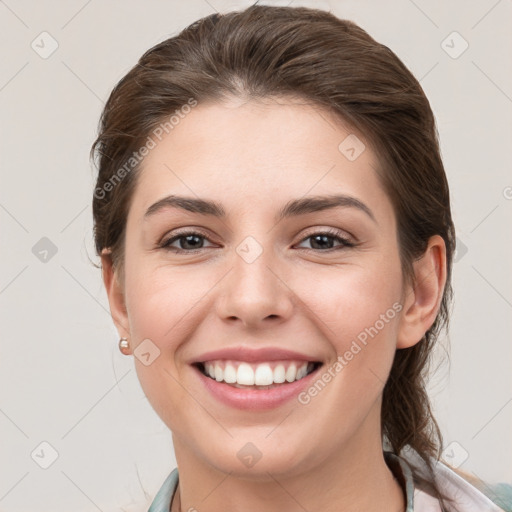 Joyful white young-adult female with medium  brown hair and grey eyes