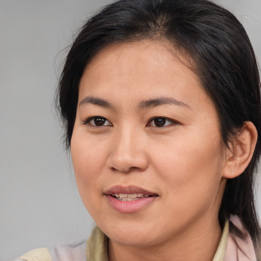 Joyful asian young-adult female with medium  brown hair and brown eyes