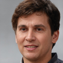 Joyful white adult male with short  brown hair and brown eyes