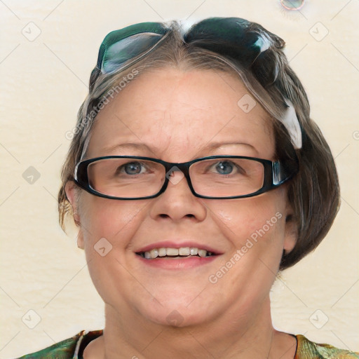 Joyful white adult female with medium  brown hair and blue eyes