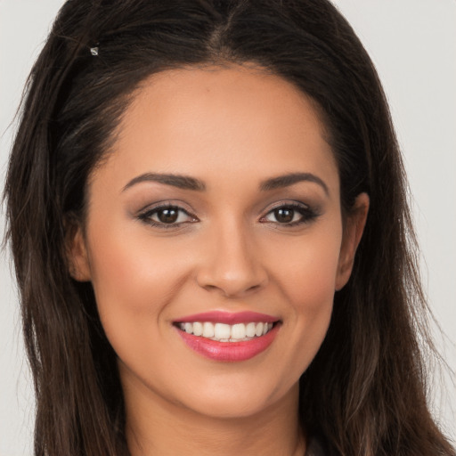 Joyful white young-adult female with long  brown hair and brown eyes