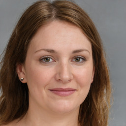 Joyful white adult female with medium  brown hair and grey eyes