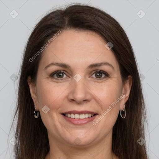 Joyful white adult female with long  brown hair and grey eyes