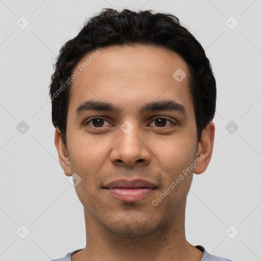 Joyful latino young-adult male with short  black hair and brown eyes